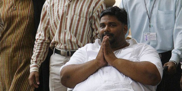 New Delhi, INDIA: Rashtriya Janta Dal (RJD) Member of Parliament Rajesh Ranjan alias Pappu Yadav (C) arrives in a wheelchair to cast his vote in the Indian Presidential election at parliament in New Delhi, 19 July 2007. The Delhi High Court permitted controversial Rashtriya Janta Dal (RJD) MP Rajesh Ranjan alias Pappu Yadav to cast his vote in the presidential election on a day when the Supreme Court decided to hear a petition seeking to bar jailed MPs from casting their ballot.The court, however, made it clear that Pappu Yadav can be taken to Parliament House polling station only for two hours anytime between 10 am and 5 pm on the polling day. AFP PHOTO/Prakash SINGH (Photo credit should read PRAKASH SINGH/AFP/Getty Images)