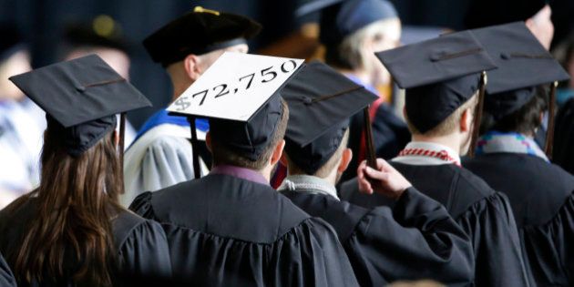 A student in line for his diploma wears a cap decorated with the cost of his education during graduation ceremonies at the University of Idaho in Moscow, Idaho., Saturday, May 16, 2015. (AP Photo/Orlin Wagner)