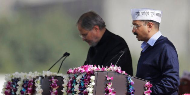 Aam Aadmi Party, or Common Man's Party, leader Arvind Kejriwal takes the oath of office as Delhi's new Chief Minister, in New Delhi, India, Saturday, Feb. 14, 2015. The AAP, headed by the former tax official who had remade himself into a champion for clean government, won 67 of the 70 seats in recent elections. Kejriwal and the party he created routed the country's best-funded and best-organized political machine and dealt an embarrassing blow to Prime Minister Narendra Modi. (AP Photo/Altaf Qadri)