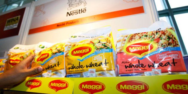In this photo taken on April 21, 2010, a man picks up a package of Maggi instant noodle made of whole wheat manufactured by Nestle Malaysia at the 7th World Instant Noodle Summit in Kuala Lumpur, Malaysia. More than a half-century after his father invented instant noodles to feed Japan's war-ravaged masses, Koki Ando says it is time to change the high-calorie, salt-laden fast food into healthier fare for the fastidious. In Malaysia, leading manufacturer Maggi is promoting