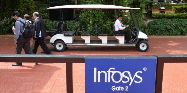 Employees of Infosys walk inside the lush green premises as the company announces its first quarter results at their Bangalore facility on July 11, 2014. Indian outsourcing giant Infosys reported on July 11 a better-than-expected 21 percent jump in quarterly net profit, after winning new deals from US clients. AFP/Manjunath KIRAN (Photo credit should read Manjunath Kiran/AFP/Getty Images)