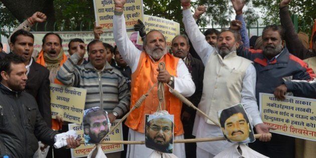 Rashtrawadi Shiv Sena (RSS) leader, Jai Bhagwan GoyalÂ (C), with party activists, holds the effigies of underworld don Dawood Ibrahim, who is wanted for the 1993 Mumbai bombings, (R), Pakistan chief of Jamaat-ud-Dawa, Hafiz Muhammad Saeed (C) and a leader of Lashkar-e-Taiba and 2008 Mumbai attacks accused, Zaki-ur-Rehman Lakhvi during a protest in New Delhi on December 21, 2014. The protestors were demanding the handover of the three men. AFP PHOTO / SAJJAD HUSSAIN (Photo credit should read SAJJAD HUSSAIN/AFP/Getty Images)