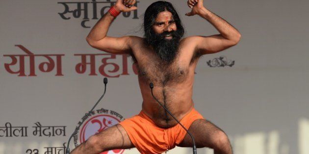 Indian yoga guru Baba Ramdev performs yoga at the 'Yoga Mahotsav' in New Delhi on March 23, 2014. Ramdev is launching a 'Yoga Mahotsav' across India with millions of people scheduled to take part in yoga sessions including Bharatiya Janata Party (BJP) Prime Ministerial candidate for India's forthcoming general election and Chief Minister of the western Indian state of Gujarat Narendra Modi. India, the world's biggest democracy, announced the start of national elections on April 7 that are expected to bring Hindu nationalist Narendra Modi to power on a platform of economic revival. AFP PHOTO /SAJJAD HUSSAIN (Photo credit should read SAJJAD HUSSAIN/AFP/Getty Images)