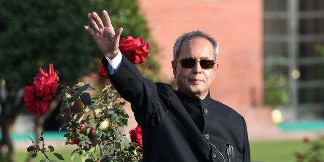 Indian President Pranab Mukherjee gestures to media during a photocall at The Mughal Garden at the Presidential Palace in New Delhi on February 13, 2015. The 15-acre area of the Mughal Gardens of Rashtrapati Bhawan was designed by Sir Edwin Lutyens and have been opened for the annual public viewing from February 14-March 15. AFP PHOTO/ PRAKASH SINGH (Photo credit should read PRAKASH SINGH/AFP/Getty Images)