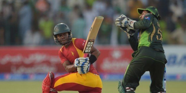 Zimbabwe batsman Chamu Chibhabha (L) is caught behind by Pakistani wicketkeeper Sarfraz Ahmed for 99 runs during the second one day international match between Pakistan and Zimbabwe at the Gaddafi Cricket Stadium in Lahore on May 29, 2015. AFP PHOTO / AAMIR QURESHI (Photo credit should read AAMIR QURESHI/AFP/Getty Images)
