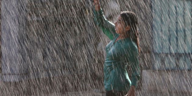 An Indian girl dances in artificial rain at Jalavihar water park on a hot summer day in Hyderabad, India, Tuesday, May 19, 2015. Heat wave continued in many parts of northern Indian even as capital Delhi witnessed season's first severe storm on Tuesday bringing temporary relief from the heat, according to local reports. (AP Photo/Mahesh Kumar A.)