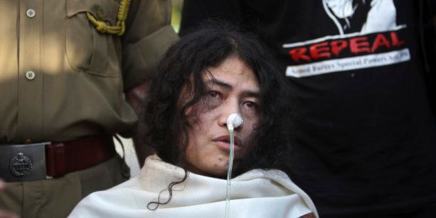 FILE â In this March 4, 2013 file photo, an Indian policeman, left, and a supporter stand behind India's most famous prisoner of conscience Irom Sharmila, who has been on a hunger strike for 12 years to protest an Indian law that suspends many human rights protections in areas of conflict, during a press conference, in New Delhi, India. India's government has decided to decriminalize suicide attempts, which earlier were punishable by up to a year in prison, a crime for which Sharmila has been in judicial custody for years. Junior Home Minister Haribhai Parathibhai Chaudhary told Parliament on Wednesday, Dec. 10, that if a person attempts suicide and survives, he or she will no longer be treated as a criminal, with the government removing Section 309 of the Penal Code from the statute book. (AP Photo/Tsering Topgyal, File)