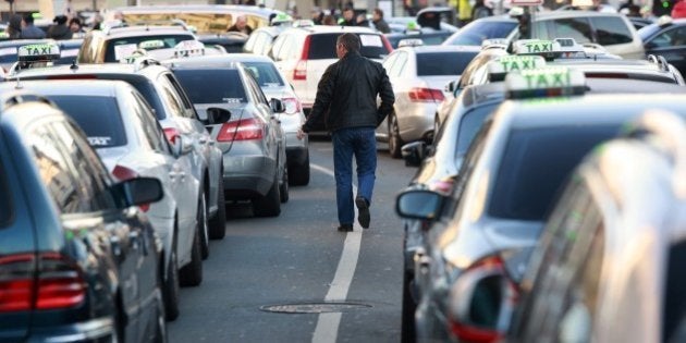 Some 400 taxis drivers block the area of Bordeaux's train station, southwestern France, as they take part in a demonstration on February 10, 2015 to protest against the growing number of minicabs, known in France as Voitures de Tourisme avec Chauffeurs (VTC) and especially the Taxi app offered by Uber, UberPOP, which they consider being unfair competition. AFP PHOTO / NICOLAS TUCAT (Photo credit should read NICOLAS TUCAT/AFP/Getty Images)