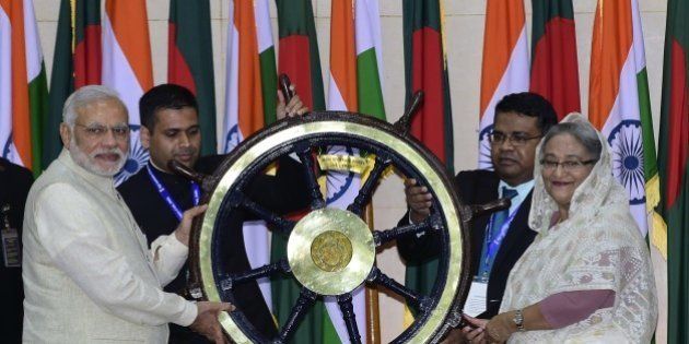 Indian Prime Minister Narendra Modi (L) hands over the steering wheel of INS Vikrant to Sheikh Hasina Wajid (R) at the Prime Minister's Office in Dhaka on June 6, 2015. Bangladesh and India on June 6 sealed a historic land pact to swap territories, which will finally allow tens of thousands of people living in border enclaves to choose their nationality after decades of stateless limbo. AFP PHOTO/ Munir uz ZAMAN (Photo credit should read MUNIR UZ ZAMAN/AFP/Getty Images)