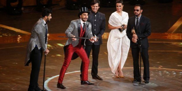Bollywood actor Ranveer Singh, second left, entertains the audience at the International Indian Film Academy (IIFA) awards in Kuala Lumpur, Malaysia, Sunday, June 7, 2015. The three day event concludes Sunday. (AP Photo/Joshua Paul)