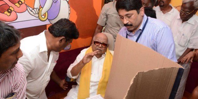 Former Chief Minister of the southern Indian state of Tamil Nadu and President of the Dravida Munnetra Kazhagam (DMK) M.K. Karunanidhi (C) along with his grand-nephew and former union minister, Dayanidhi Maran (C-R) arrives to cast his vote during the national elections at a polling station in Chennai on April 24, 2014. The mammoth national election has been staggered in a bid to ensure the safety of the 814-million-strong electorate, with results due on May 16 when the opposition Bharatiya Janata Party (BJP) is forecast to take power. AFP PHOTO/STR (Photo credit should read STRDEL/AFP/Getty Images)
