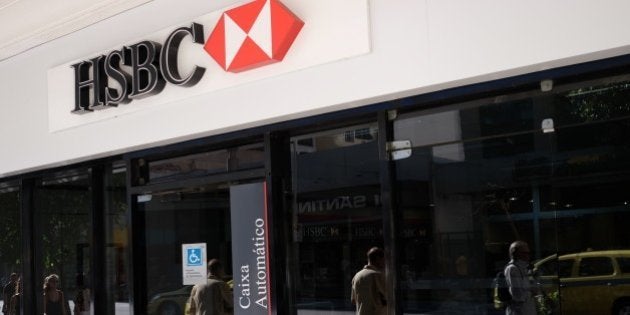 View of the facade of a HSBC bank cash dispenser, following the announcement of the bank to close HSBC Brazil, at Cinelendia square, downtown Rio de Janeiro on June 9, 2015. Scandal-hit bank HSBC said Tuesday it would cut its global headcount by up to 50,000 as part of a restructuring that entails its withdrawal from Brazil and Turkey, while it also mulls abandoning London as its HQ. AFP PHOTO / CHRISTOPHE SIMON (Photo credit should read CHRISTOPHE SIMON/AFP/Getty Images)