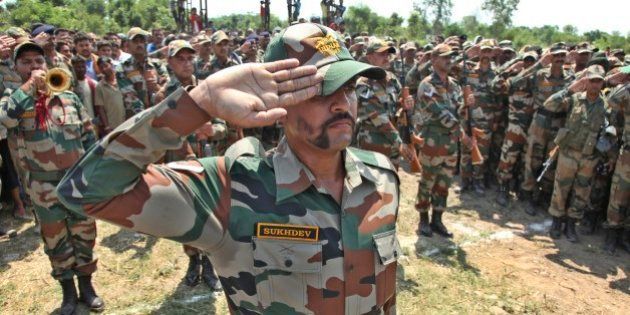 Indian army soldiers pay tribute to their colleague Randeep Singh, who was killed in Thursdayâs rebel attack in northeastern Manipur state after his body was brought to Akhnoor, Jammu and Kashmir state, India, Sunday, June 7, 2015. A group of rebels using rocket-propelled grenades and automatic weapons ambushed a military convoy in India's insurgency-wracked northeast on Thursday, killing more than a dozen soldiers in the latest major attack in the region in recent months. (AP Photo/Channi Anand)