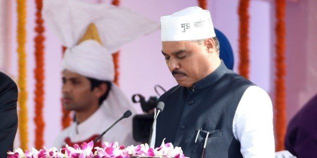 Delhi's Lieutenant Governor Najib Jung (L) adminsters the oath to Aam Aadmi Party (AAP) leader Jitender Singh Tomar during the Delhi state swearing-in ceremony in New Delhi on February 14, 2015. AAP president Arvind Kejriwal promised to make Delhi India's first corruption-free state and end what he called its 'VIP culture' as he was sworn in as chief minister before a huge crowd of cheering supporters. AFP PHOTO / PRAKASH SINGH (Photo credit should read PRAKASH SINGH/AFP/Getty Images)
