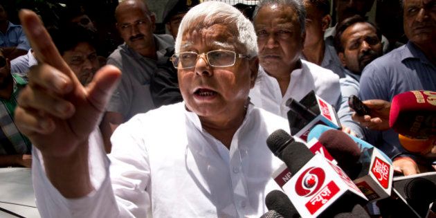 Rashtriya Janata Dal (RJD) leader Lalu Prasad Yadav speaks to reporters after a meeting with Samajwadi Party (SP) leader Mulayam Singh Yadav in New Delhi, India, Friday, May 22, 2015. The leaders reportedly met to sort out seat sharing issues ahead of the Bihar state elections, expected later this year. (AP Photo/Saurabh Das)