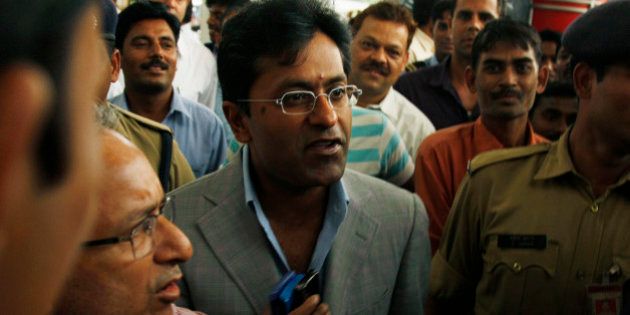 Suspended Indian Premier League Chairman Lalit Modi, center, is surrounded by bodyguards, media, and onlookers as he arrives at the airport from a flight in New Delhi, India, Wednesday, April 28, 2010. Modi was suspended Sunday and is under investigation on allegations of corruption dating back to the IPL's inaugural season in 2008. (AP Photo/Saurabh Das)