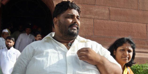 Member of Parliament from India's Rashtriya Janata Dal (RJD) Pappu Yadav (L), who is serving a life sentence in New Delhi's Tihar jail on charges of murdering a Communist Party of India-Marxist leader, walks towards parliament house in New Delhi on July 22, 2008. India's embattled coalition government will go into a parliamentary confidence vote with a tiny advantage but the margin is so tight it has no guarantee of surviving, Indian media say. The Congress party-led coalition government requires a simple majority to survive the vote after its left-wing allies withdrew support earlier this month over their opposition to a nuclear energy agreement with the United States. AFP PHOTO/Prakash SINGH (Photo credit should read PRAKASH SINGH/AFP/Getty Images)