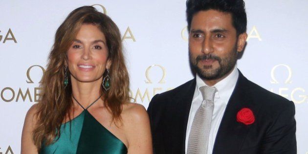 US model Cindy Crawford and Indian Bollywood actor Abhishek Bachchan pose as they arrive to attend a promotional event in Mumbai late June 18, 2015. AFP PHOTO/STR (Photo credit should read STRDEL/AFP/Getty Images)
