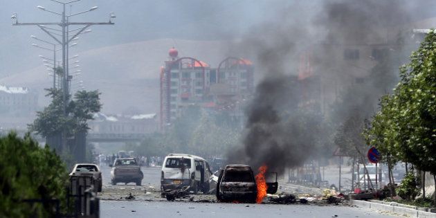Fire and smokes rise at the site of a suicide attack during clashes with Taliban fighters in front of the Parliament, in Kabul, Afghanistan, Monday, June 22, 2015. The Taliban launched a complex attack on the Afghan parliament Monday, with a suicide car bomber striking at the entrance and gunmen battling police as lawmakers were meeting inside to confirm the appointment of a defense minister, police and witnesses said. (AP Photo/Massoud Hossaini)