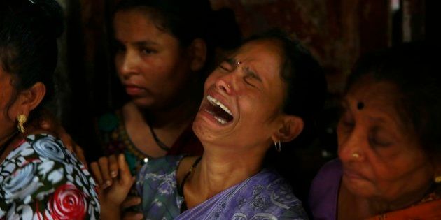 A relative of Lata Jadhav, one among the dozens who died after drinking tainted liquor, cries during her funeral in Mumbai, India, Sunday, June 21, 2015. Deaths from illegally brewed alcohol are common in India because the poor cannot afford licensed liquor. Illicit liquor is often spiked with chemicals such as pesticides to increase its potency. (AP Photo/Rafiq Maqbool)