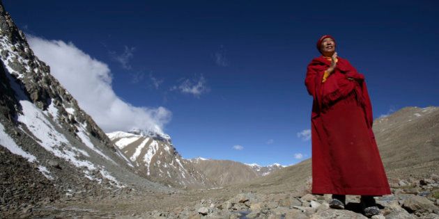 PURANG COUNTY, CHINA - JUNE 16: (CHINA OUT) A nun from Nepal worships the snow-capped Kangrinboqe Mountain, known as Mt. Kailash in the West, June 16, 2007 in Purang County of Tibet Autonomous Region, China. Kangrinboqe, meaning 'the holy mountain' in Tibetan, is the summit of Gangdise Mountains with an altitude around 6,638 meters (21,778 feet) above sea-level. It is considered a sacred place in four religions, Hinduism, Buddhism, Jainism and Bon faith. Every year, thousands of pilgrims, including Tibetans, overseas religious devotees from India, Nepal and Bhutan, make pilgrimages to Kangrinboqe, following a tradition dating back thousands of years. Some of pilgrims take a year or longer to reach the sacred mountain. (Photo by China Photos/Getty Images)