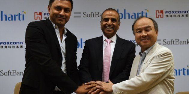 Chairman of Bharti Enterprises Sunil Bharti Mittal (C), CEO of SoftBank Masayoshi Son (R) and Chairman of SoftBank Corp Nikesh Arora (L) shake hands before the start of a press conference in New Delhi on June 22, 2015. Japan's SoftBank will team up with Taiwan's Foxconn and India's Bharti Enterprises to invest $20 billion in solar power projects in India, as the country ramps up its clean energy sector, the companies announced. AFP PHOTO/MONEY SHARMA (Photo credit should read MONEY SHARMA/AFP/Getty Images)