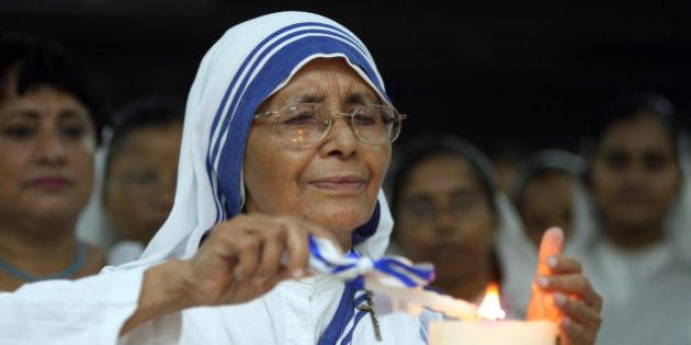 Sister Nirmala, successor to Mother Teresa, lights a candle as he is joined by fellow nuns and volunteers of the Missionaries of Charity to celebrate the 97th birth anniversary of Mother Teresa at the Mother House at the Missionaries of Charity in Kolkata, 26 August 2007. Hundreds of nuns of the house with a number of volunteers took part in the morning service to mark the day. Mother Teresa was born 26 August, 1910 in what is now Skopje, Macedonia. AFP PHOTO/Deshakalyan CHOWDHURY (Photo credit should read DESHAKALYAN CHOWDHURY/AFP/Getty Images)