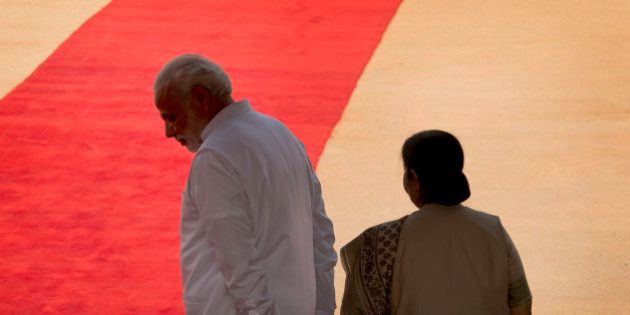 Indian Prime Minister Narendra Modi, left, and Foreign Minister Sushma Swaraj wait for the arrival of Tanzanian President Jakaya Kikwete at the Indian presidential palace in New Delhi, India, Friday, June 19, 2015. Opposition parties in India are demanding the resignation of Swaraj over her decision to help a controversial Indian cricket official and businessman Lalit Modi living in the UK, according to local news agency Press trust of India. (AP Photo/Manish Swarup)