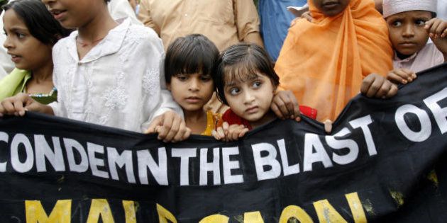 Kolkata, INDIA: Indian Muslim children shout slogans as they march with a banner during a protest rally in Kolkata, 09 September 2006, a day after bomb blasts killed 31 people in the western Indian town of Malegaon. Relatives buried their dead after three bombs outside a mosque and graveyard targeted Muslim worshippers leaving the mosque in the town, the scene of previous clashes between Hindus and Muslims. AFP PHOTO/Deshakalyan CHOWDHURY (Photo credit should read DESHAKALYAN CHOWDHURY/AFP/Getty Images)