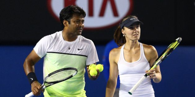 MELBOURNE, AUSTRALIA - FEBRUARY 01: Martina Hingis of Switzerland and Leander Paes of India celebrate winning their final mixed doubles match against Kristina Mladenovic of France and Daniel Nestor of Canada during day 14 of the 2015 Australian Open at Melbourne Park on February 1, 2015 in Melbourne, Australia. (Photo by Cameron Spencer/Getty Images)