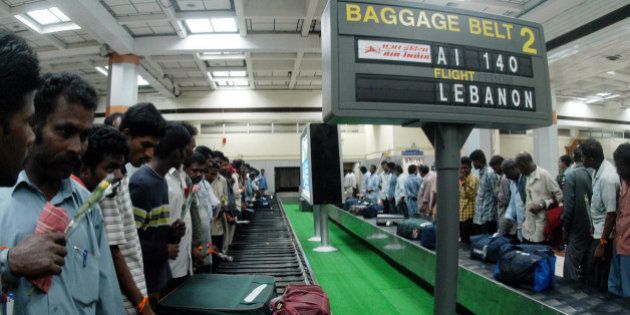 Indians from Lebanon wait for their baggage near a conveyor belt inside Madras international airport in Madras, India, Friday, July 21, 2006. 341 Indians evacuated from troubled Lebanon by ship to the Cypriot city of Larnaca, were airlifted to Madras late Friday night. (AP Photo/M.Lakshman)