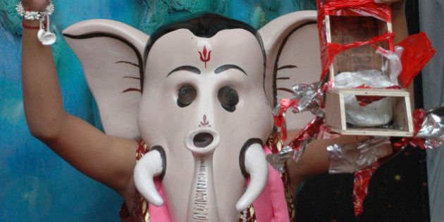 A man dressed as the Hindu elephant headed god Ganesha enacts defusing a bomb during Ganesh festival in Ahmadabad, India, Wednesday, Sept.3, 2008. Serial bombings in the city last month had killed 58 people. (AP Photo/Ajit Solanki)