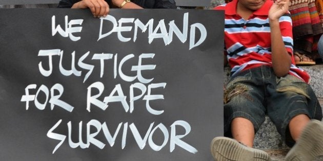 Activists from various women's rights organisation and children stage a silent demonstration against sexual assault and rapes on women, in Bangalore on April 22, 2015. AFP PHOTO/Manjunath KIRAN (Photo credit should read MANJUNATH KIRAN/AFP/Getty Images)