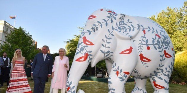 Britain's Prince Charles (C), Prince of Wales and Britain's Camilla, Duchess of Cornwall host a reception in support of the Elephant family, a charity set up by Mark Shand, the Duchess of Cornwall's brother in London on June 30. 2015. The event called Travels to my Elephant will see painted rickshaws auctioned to raise money for Asian Elephants and later this year taking part in a race across Madhya Pradesh in India.AFP PHOTO / BEN STANSALL (Photo credit should read BEN STANSALL/AFP/Getty Images)