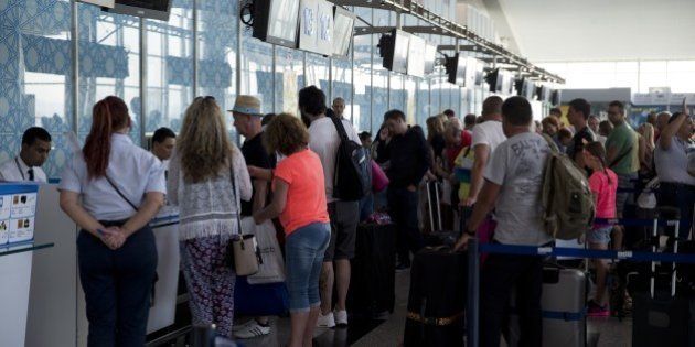 British tourists queue up at the check-in counter at the Enfidha International airport on June 28, 2015, as they leave Tunisia two days after a shooting attack on the Riu Imperial Marhaba Hotel in Port el Kantaoui, on the outskirts of Sousse south of the capital Tunis. The attack saw a Tunisian student disguised as a tourist pull out a Kalashnikov assault rifle hidden inside a beach umbrella and open fire on holidaymakers at a popular beach resort killing 38 people, most of them British tourists, in the worst attack in the country's recent history. AFP PHOTO / KENZO TRIBOUILLARD (Photo credit should read KENZO TRIBOUILLARD/AFP/Getty Images)