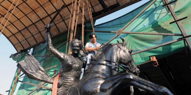 Indian craftswoman Jasuben Shilpi, known as the Bronze Woman of India, gives finishing touches to a life-size bronze statue of 'Jhansi-Ki-Rani or Queen Of Jhansi' - Rani Laxmi Bai - at her workshop near Adalaj, some 25 kms from Ahmedabad, on February 3, 2011. The 3.5 ton statue will be installed at Jamnagar this February 5. AFP PHOTO / Sam PANTHAKY (Photo credit should read SAM PANTHAKY/AFP/Getty Images)