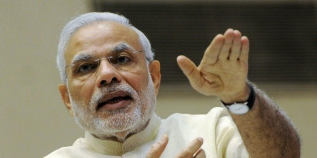 Indian Prime Minister Narendra Modi gestures as he addresses a ceremony at the launch of 'Smart Cities Mission, Atal Mission for Rejuvenation and Urban Transformation (AMRUT)' in New Delhi on June 25, 2015. AFP PHOTO/STR (Photo credit should read STRDEL/AFP/Getty Images)