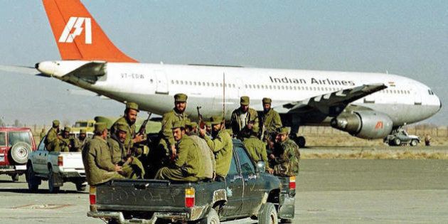 KANDAHAR, AFGHANISTAN: (FILES) In this picture taken 30 December 1999, Taliban Islamic militia commandos ride in the rear of a truck towards an aircraft of Indian Airlines hijacked by Islamic Kahsmiri militants which stands on the tarmac at Kandahar airport. An document reported to be from al-Qaeda released 05 February, has hailed the 1999 hijacking of the Indian Airlines aicraft as a 'successful operation' from which other guerrillas can learn lessons. The plane was hijacked after it left the Nepalese capital, Kathmandu, en route to New Delhi on 24 December 1999, and later landed in the Afghan city of Kandahar. AFP PHOTO/ Saeed KHAN (Photo credit should read SAEED KHAN/AFP/Getty Images)