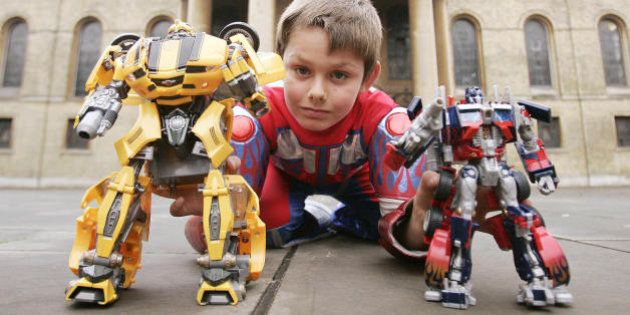 A boy plays with 'Transformer robots,' at a photocall in central London, 10 October 2007, as the Toy Retailers Association unveils this year's official Top Toy predictions for Christmas. AFP PHOTO/SHAUN CURRY (Photo credit should read SHAUN CURRY/AFP/Getty Images)