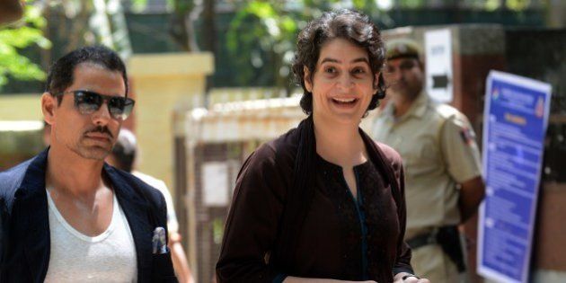 Priyanka Gandhi (R), daughter of India's Congress Party president Sonia Gandhi, and her husband Robert Vadra arrive at a polling station to cast their votes in New Delhi on April 10, 2014. The third phase of voting in India's national elections began at 7:00 am (0130 GMT) in 91 constituencies, representing nearly a fifth of the 543-seat lower house, across the capital and 13 other states, including Maoist insurgency-hit eastern India. AFP PHOTO/RAVEENDRAN (Photo credit should read RAVEENDRAN/AFP/Getty Images)