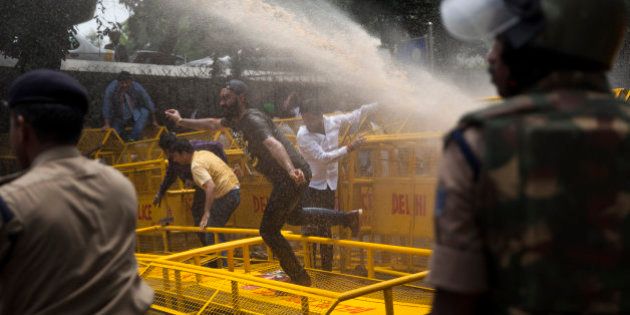 Police use water canon to disperse activists of India's Congress party's youth wing as they protest against Shivraj Singh Chauhan, chief minister of the central Indian state of Madhya Pradesh, in New Delhi, India, Wednesday, July 8, 2015. Protests against Chauhan and his administration has peaked in recent days after several witnesses in a case alleging a massive scheme to manipulate the results of entrance examinations for government jobs and medical colleges in Madhya Pradesh died under mysterious circumstances. The alleged scam has been labeled âVyapamâ by Indian media after the Hindi name of the stateâs professional examination board since the story first surfaced in 2013. (AP Photo/Tsering Topgyal)