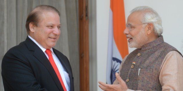India's newly sworn-in Prime Minister Narendra Modi (R) talks with Pakistani Prime Minister Nawaz Sharif as they shake hands during a meeting in New Delhi on May 27, 2014. Indian Prime Minister Narendra Modi met his Pakistani counterpart Nawaz Sharif for landmark talks in New Delhi May 27 in a bid to ease tensions between the nuclear-armed neighbours. AFP PHOTO/RAVEENDRAN (Photo credit should read RAVEENDRAN/AFP/Getty Images)