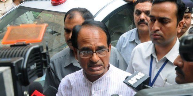 Indian Chief Minister of the state of Madhya Pradesh Shivraj Singh Chauhan talks to media outside the Ministry of External Affairs in New Delhi on July 8, 2015. The embattled chief minister of India's Madhya Pradesh state July 7, 2015 asked federal investigators to carry out an independent probe into a jobs scandal after a spate of deaths which opponents have linked to the scam. Nearly 2,000 people have been arrested since 2013 over the so-called Vyapam scandal in which thousands of people are alleged to have paid bribes in return for jobs on the state payroll or for places in educational institutes. AFP PHOTO / STR (Photo credit should read STRDEL/AFP/Getty Images)