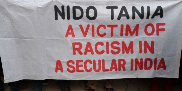 Indian students from the northeastern states and supporters hold a banner as they protest the death of northeastern student Nido Tania in New Delhi on February 2, 2014. The 19-year-old student Nido Tania, son of Congress MLA and Parliamentary Secretary in Health and Family Welfare Department Nido Pavitra, was allegedly beaten up by shopkeepers January 29, following an altercation sparked by their taunts on his hairstyle.Â Taniam, the son of a state legislator, was found dead a day later. AFP PHOTO/SAJJAD HUSSAIN (Photo credit should read SAJJAD HUSSAIN/AFP/Getty Images)