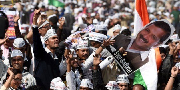 Supporters of the Aam Aadmi Party (AAP) shout slogans as they watch leader Arvind Kejriwal being sworn in as Delhi chief minister by Delhi Lieutenant Governor Najeeb Jung during the ceremony at Ramlila Grounds in New Delhi on February 14, 2015. Â Arvind Kejriwal promised to makeÂ DelhiÂ India's first corruption-free state and end what he called its 'VIP culture' as he was sworn in as chief minister before a huge crowd of cheering supporters. AFP PHOTO / SAJJAD HUSSAIN (Photo credit should read SAJJAD HUSSAIN/AFP/Getty Images)