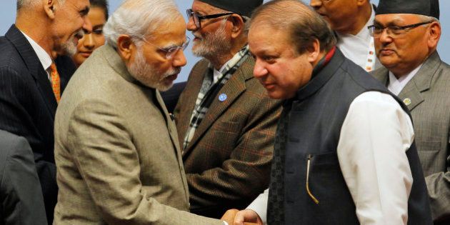 Pakistani Prime Minister Nawaz Sharif, right, moves closer to listen to Indian Prime Minister Narendra Modi as they shake hands during closing ceremony of the 18th summit of the South Asian Association for Regional Cooperation (SAARC) in Katmandu, Nepal, Thursday, Nov. 27, 2014. South Asian heads of state attending their first summit in three years reached a deal on energy sharing Thursday, but failed on two other economic agreements during a retreat where Indian and Pakistan leaders shook hands. (AP Photo/Niranjan Shrestha, Pool)