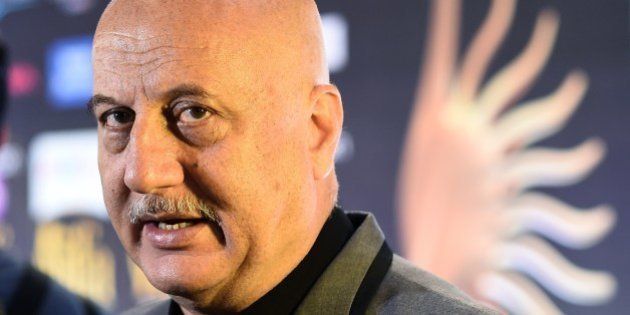 Bollywood actor Anupam Kher speaks to the media on the green carpet at the Tampa Convention Center ahead of IIFA Rocks on the second day of the 15th International Indian Film Academy (IIFA) Awards in Tampa, Florida, April 24, 2014. AFP PHOTO JEWEL SAMAD (Photo credit should read JEWEL SAMAD/AFP/Getty Images)