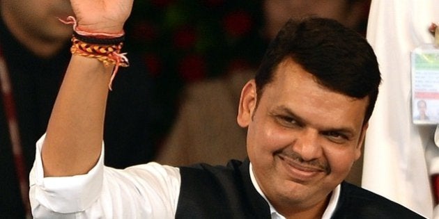 India's Maharashtra state new Chief Minister and BJP leader Devendra Fadnavis waves towards crowd after his swearing-in ceremony in Mumbai on October 31, 2014. India's ruling Bharatiya Janata Party (BJP) snatched election victory on October 19 in two key Indian states, tightening its grip on power after storming to government nationally five months ago. AFP PHOTO/ PUNIT PARANJPE (Photo credit should read PUNIT PARANJPE/AFP/Getty Images)