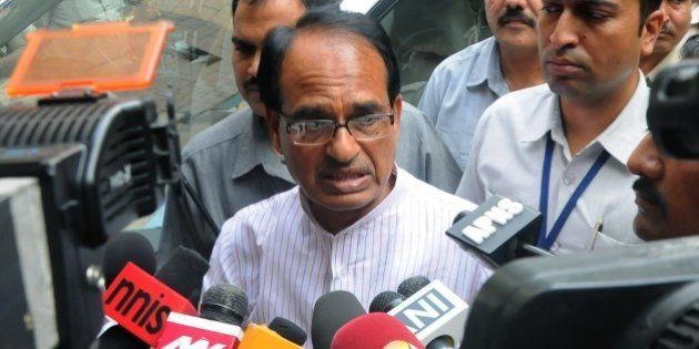 Indian Chief Minister of the state of Madhya Pradesh Shivraj Singh Chauhan talks to media outside the Ministry of External Affairs in New Delhi on July 8, 2015. The embattled chief minister of India's Madhya Pradesh state July 7, 2015 asked federal investigators to carry out an independent probe into a jobs scandal after a spate of deaths which opponents have linked to the scam. Nearly 2,000 people have been arrested since 2013 over the so-called Vyapam scandal in which thousands of people are alleged to have paid bribes in return for jobs on the state payroll or for places in educational institutes. AFP PHOTO / STR (Photo credit should read STRDEL/AFP/Getty Images)