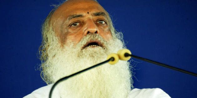 Indian spiritual leader Asaram Bapu addresses supporters at the sect's Ashram (Spiritual Centre) on the outskirts of Ahmedabad on July 18, 2008. Violent clashes broke out, during which ashram inmates attacked media representatives, in the wake of protests calling for the closure of the ashram following the discovery on July 6, 2008 of the bodies of two male youth inmates in the vicinity of the ashram. AFP PHOTO/ Sam PANTHAKY (Photo credit should read SAM PANTHAKY/AFP/Getty Images)